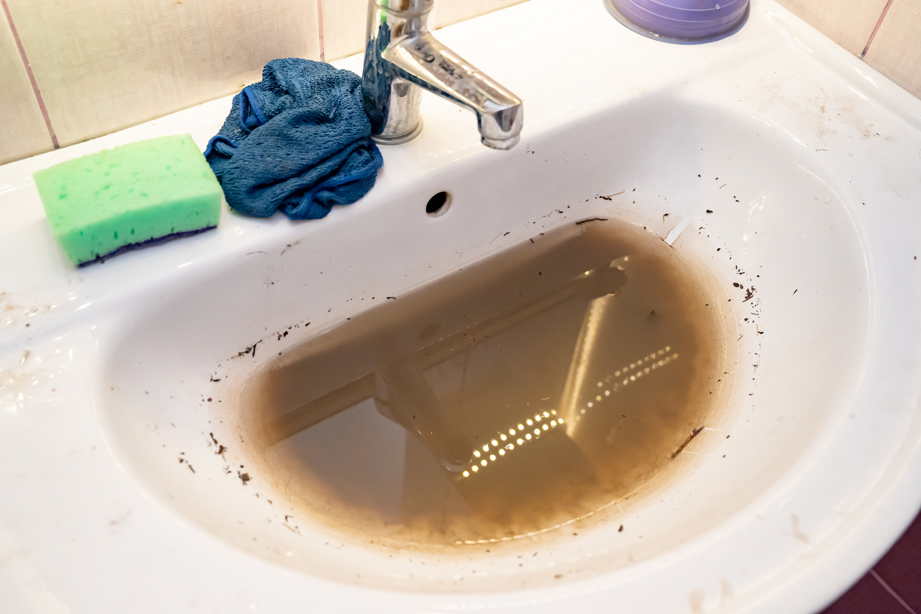 Dirty water backing up into a bathroom sink 